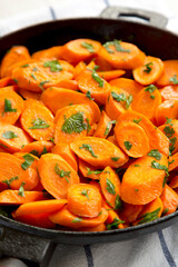 Homemade Sauteed Carrots in a cast iron pan, side view. Close-up.