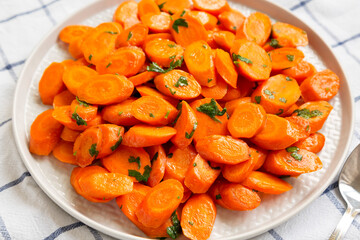 Homemade Sauteed Carrots on a plate, low angle view. Close-up.