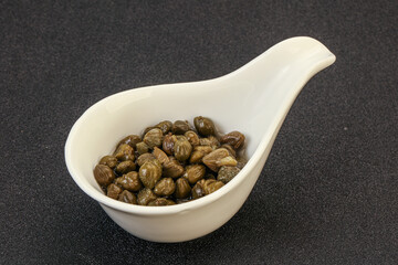 Tasty capers in the bowl