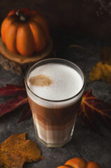 Autumn latte coffee pumpkin on dark background.