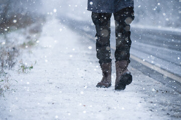 A man walking on a winter road	