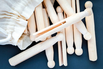 Wooden vintage retro clothes pegs in a white cloth bag