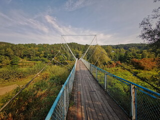 The old bridge with a blue railing over the Dunajec River. Dunajec Poland.
