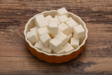 Refined white sugar cubs in the bowl