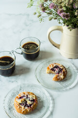 Cups of coffee and buns with jam