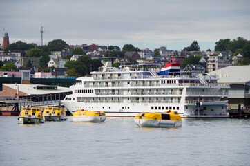 Rear view of modern cruiseship or cruise ship liner in port of Portland, Maine with life boat drill...