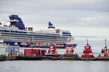 Modern Celebrity cruiseship or cruise ship liner Summit in port of Portland, Maine with tug boats...
