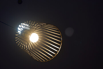 Light lamp hanging from celling with black background