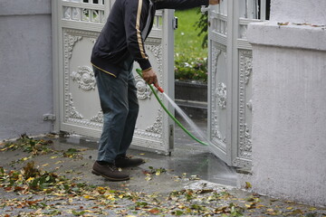 Worker washing floors on a rainy day