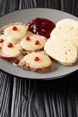 Beef Sirloin With Cream Sauce Svickova na smetane close-up in a plate on the table. Vertical