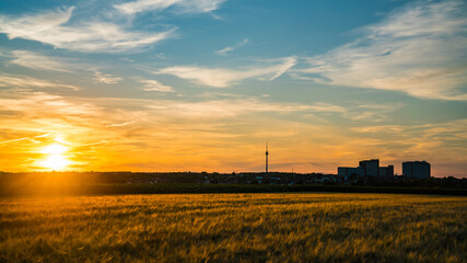Germany, Stuttgart, Romantic orange sunset sky  above fields and tv tower Fernsehturm in summer evening season © Simon Dux Media