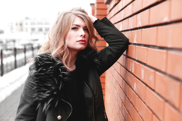 Fototapeta premium Pretty young woman walking on the city street. Casual fashion, plus size model.