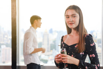Young teen business people enjoy party celebration and talking with friends or coworker and relax drinking win or champagne on roof top building