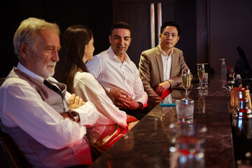 Business people enjoy talking and relax drinking alcohol in pub bar after work