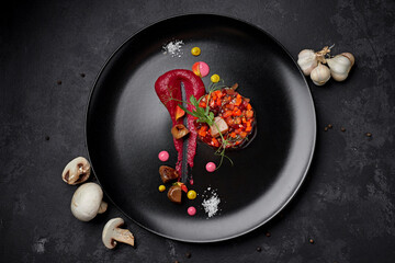 Vinaigrette salad on a black background, with mushrooms and garlic