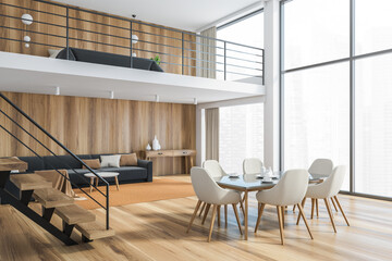 Wooden living room with white chairs and table, wooden stairs and big window