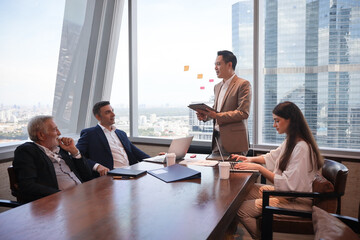 Executive business people wear suit have meeting and talking and discussing in conference room, leader present result and idea to the team by using tablet and document