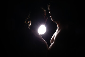 Loving couple silhouette. Couple in love. Photo. Dark background. Sensual. Romantic lovers. 