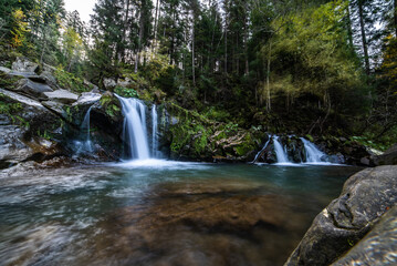 Rapid mountain river with a waterfall in the national park