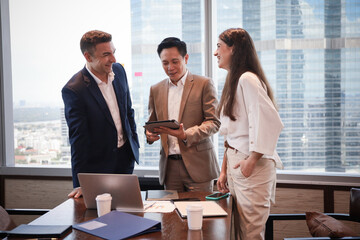 Business people standing and talking or discussing or brainstorming in meeting room