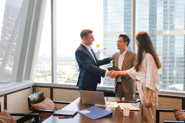Business people standing and talking or discussing or brainstorming in meeting room, leader handshake with team and admire