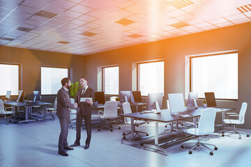 Two businessmen in gray open space office