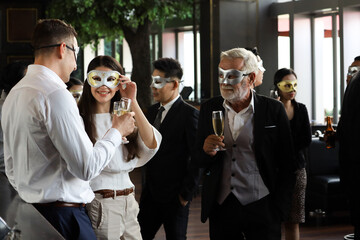 Business people or team or friend or colleague wear mask cover and drinking wine or champagne or alcohol in party after work, happy Christmas day or new year celebration