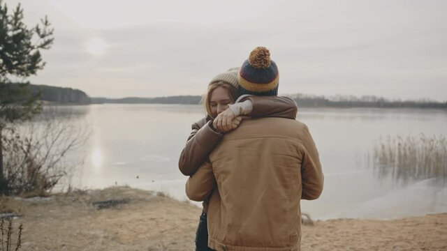Happy couple in love nearby autumn lake. Love, relationship, family concept. Filmed on cinema camera. 12 bit color space.