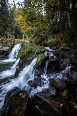 Rapid mountain river with a waterfall in the national park