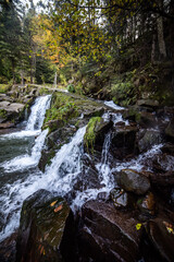 Waterfall on a mountain river in the autumn forest