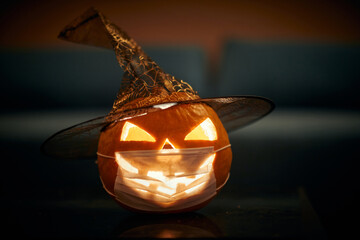 Halloween pumpkin with a carved face; Corona virus halloween concept