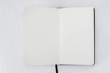 Unfold open notebook with blank white pages on light background. Sketchbook, book