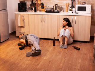 Scared wife after being beaten by drunk husband while he is sleeping on the kitchen floor....