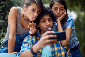 Cheerful friends taking silly selfie at the bar's backyard. Quality friendship time together