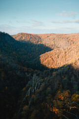 Natural autumn vibes in the mountains with soft peaceful morning light hitting the rocks and dark shadow background. Thale, Bodetal, Harz National Park, Harz Mountains in Germany