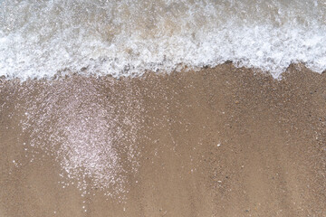 The background of sand with water splash into summer with space for text.