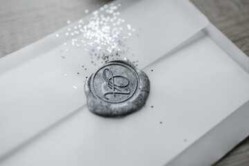 silver seal on the envelope with sequins