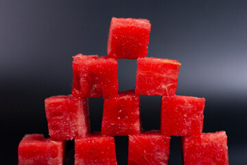Watermelon cubes are overlapped in a pyramid.