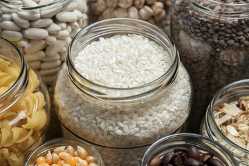 Set of glass jars with various ingredients placed on a table. Zero waste concept.