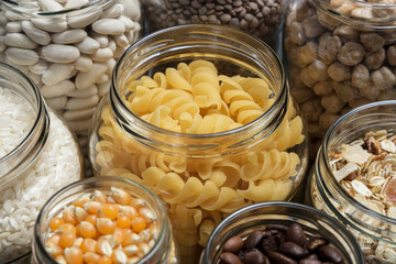 Set of glass jars with various ingredients placed on a table. Zero waste concept.