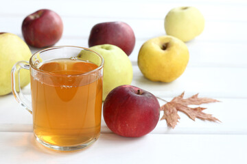 freshly squeezed juice from red, yellow and green apples. autumn vitamin drink