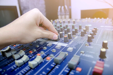 Audio mixer console and professional sound mixing with buttons and sliders.
