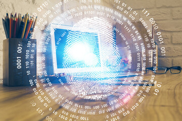 Computer on desktop in office with finger print drawing. Double exposure. Concept of business data security.