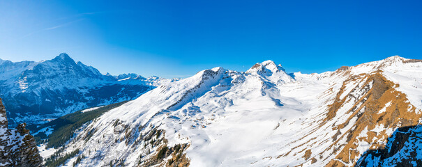 Wide panoramic view of winter landscape in Swiss Alps on the First mountain in Grindelwald, Switzerland