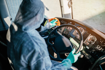 Obraz premium Professional chemical bus cleaning. Bus disinfection. Exterminator in workwear.