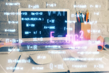 Desktop computer background and formula hologram writing. Double exposure. Education concept.