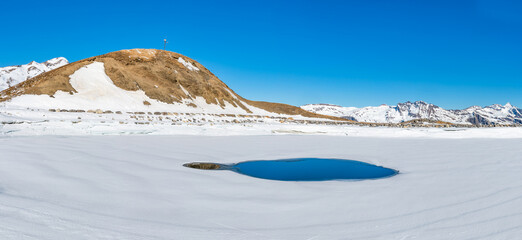 Winter landscape with snow covered peaks and frozen lake on Kleine Scheidegg mountain in Swiss Alps...