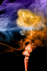 Abstract color smoke swirls on a black background.
