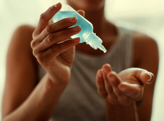 COVID-19 Pandemic Coronavirus Close up woman hands using wash hand sanitizer gel dispenser, against 2019-nCoV at home. Home isolation, Auto Quarantine, Antiseptic, Hygiene and Healthcare concept.
