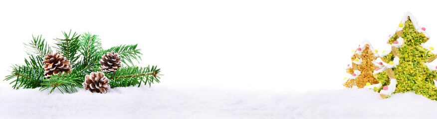 Naklejka na ściany i meble Christmas Fir Branches with Cookie Trees on Snow isolated on white Background - Panorama